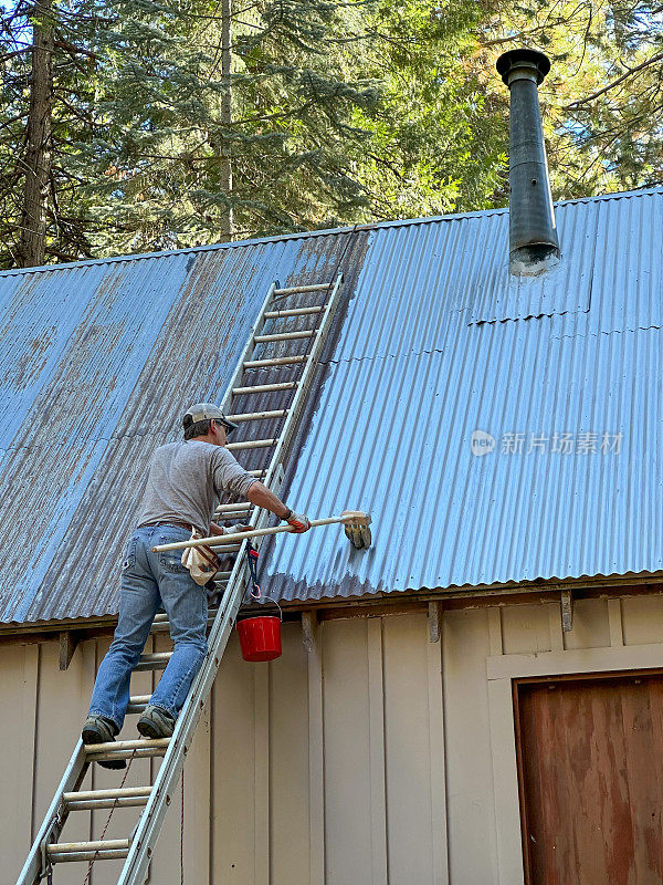 Man painting roof